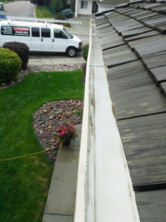Photo of a clean gutter with ALL CLEAN vehicle in the backdrop.